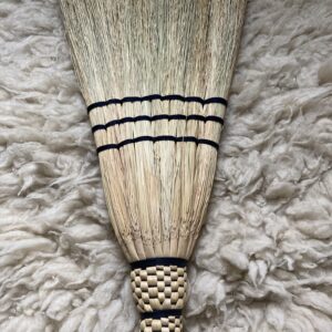 Full size homemade broom braided with black thread on a wooden ash handle.